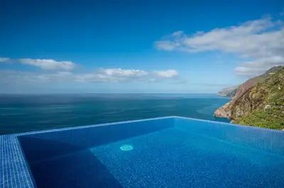 a swimming pool with a view of the ocean at Escarpa - The Madeira Hideaway in Ponta do Sol