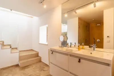 a bathroom with a sink and a mirror at Escarpa - The Madeira Hideaway in Ponta do Sol