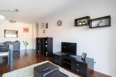 a living room with a flat screen tv on a wall at Centromar Residence Ocean View By Atlantic Holiday in Funchal