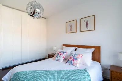 a bedroom with a bed and a chandelier at Centromar Residence Ocean View By Atlantic Holiday in Funchal