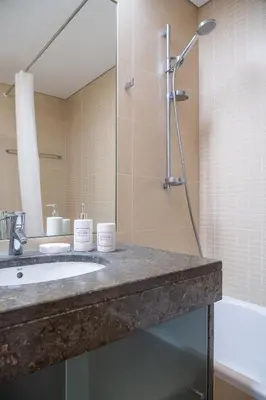 a bathroom with a sink and a shower at Centromar Residence Ocean View By Atlantic Holiday in Funchal