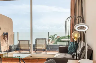 a living room with a view of the ocean at Costa Apartment - Vista Mar in Caniço