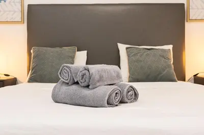a pile of towels sitting on top of a bed at Costa Apartment - Vista Mar in Caniço