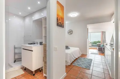 a kitchen and a bedroom with a bed in a room at Costa Apartment - Vista Mar in Caniço