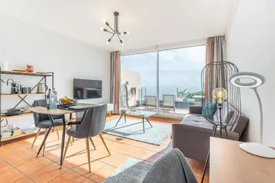 a living room with a view of the ocean at Costa Apartment - Vista Mar in Caniço