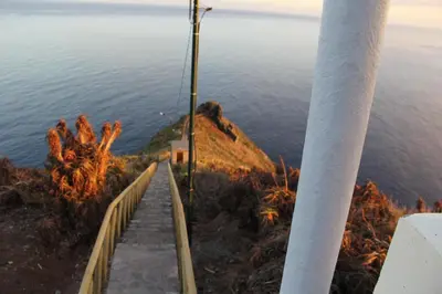 a path on the side of a hill overlooking the water at CRISTO REI APARTMENT in Caniço