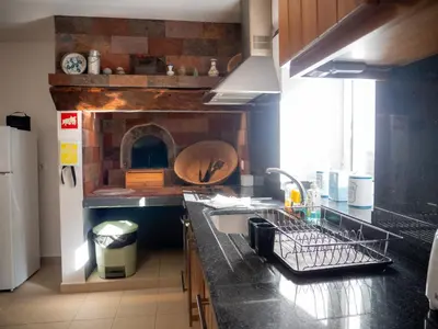 a kitchen with a sink and a counter with a oven at Casa dos Anjos in Ponta do Sol