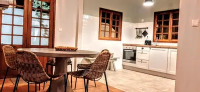 a kitchen with a table and chairs in it at Beach Tree House in Porto Santo