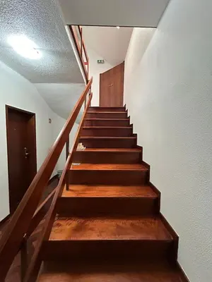 a staircase in a house with wooden steps at Palmar Rooms in Funchal