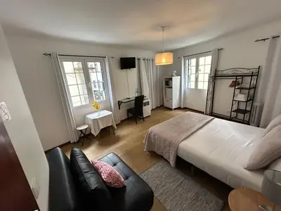 a bedroom with a bed and a couch in it at Palmar Rooms in Funchal