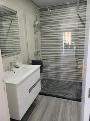 a bathroom with a white sink and a shower at Magical Sunset in Madalena do Mar