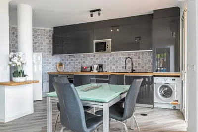 a kitchen with a table and chairs in a kitchen at Magical Sunset in Madalena do Mar