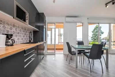 a kitchen and dining room with a table and chairs at Magical Sunset in Madalena do Mar