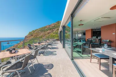 a restaurant with a view of the ocean at Engenho Velho Hotel & Restaurante - Adults Only in Arco da Calheta