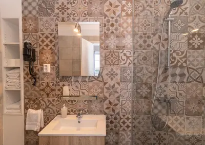 a bathroom with a sink and a shower at Vitorina Corte Guesthouse in Funchal