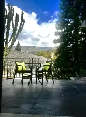 two chairs and a table on a patio at Vitorina Corte Guesthouse in Funchal