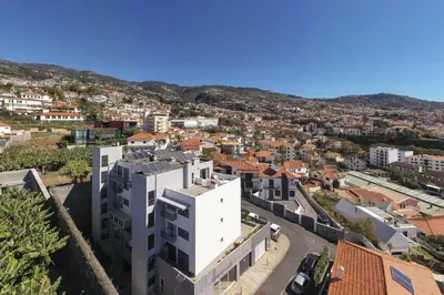 an aerial view of a white building in a city at Rooftop Funchal - By Wehost in Funchal