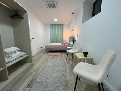 a bedroom with a bed and chairs in a room at Victoria 1942 in Funchal