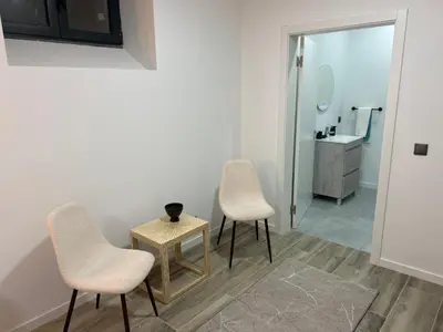 a bathroom with two chairs and a table and a sink at Victoria 1942 in Funchal
