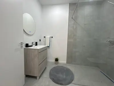 a bathroom with a shower and a sink and a mirror at Victoria 1942 in Funchal