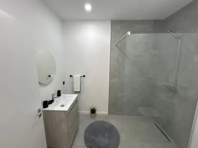 a bathroom with a shower and a sink and a mirror at Victoria 1942 in Funchal