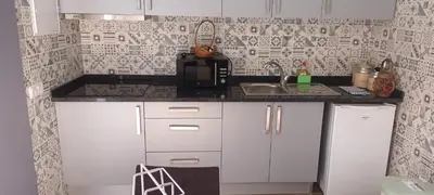 a small kitchen with a sink and a microwave at Victoria 1942 in Funchal