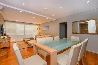 a dining room with a glass table and white chairs at Apartamento Costa Do Sol in Funchal