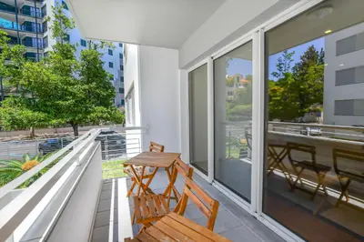 a balcony with two chairs and a table on it at Apartamento Costa Do Sol in Funchal