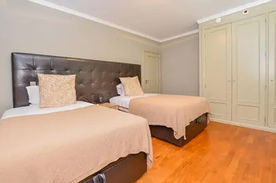 a bedroom with two beds and a large headboard at Apartamento Costa Do Sol in Funchal