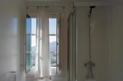 a bathroom with a shower and a window with a view at Recanto das Florenças (1) in Arco da Calheta
