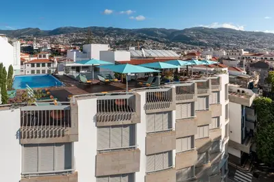 a tall building with balconies on the side of it at Hotel Madeira in Funchal