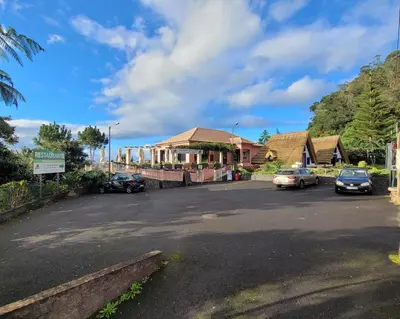 a street with cars parked in front of a building at Santana in Nature Bed & Breakfast in Santana
