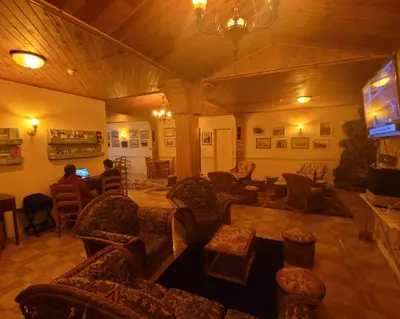 a living room with couches and a flat screen tv at Santana in Nature Bed & Breakfast in Santana