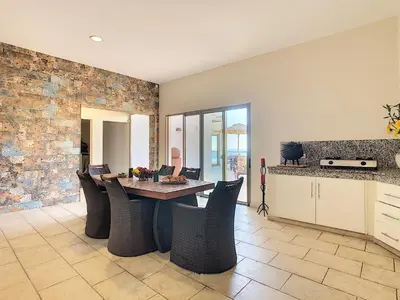 a kitchen and dining room with a table and chairs at Villa Moniz by LovelyStay in Funchal