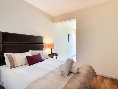 a bedroom with a large bed with a black headboard at Villa Moniz by LovelyStay in Funchal