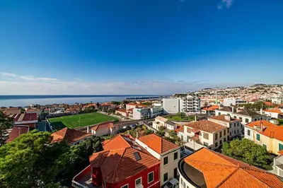 an aerial view of a city with buildings and the ocean at Alegria I by An Island Apart in Funchal