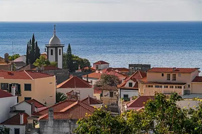 a view of a town with a church and the ocean at Alegria I by An Island Apart in Funchal