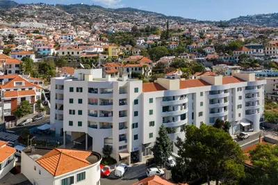an aerial view of a white building in a city at Alegria I by An Island Apart in Funchal