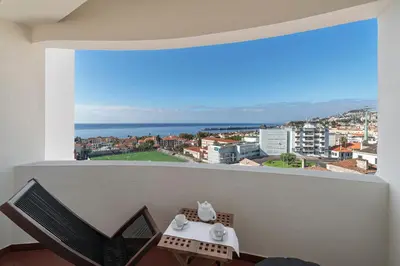 a balcony with a table and a view of the ocean at Alegria I by An Island Apart in Funchal