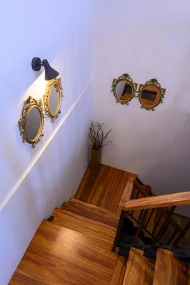 two mirrors on the wall next to a stairway at Recanto das Florenças (2) in Arco da Calheta