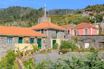 a group of houses with orange roofs at Recanto das Florenças (2) in Arco da Calheta