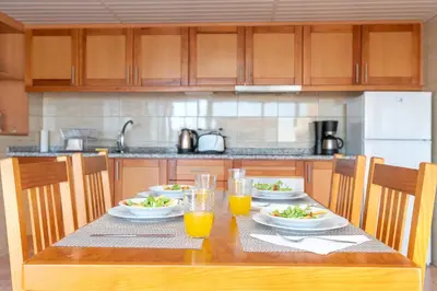 a table with plates of food and glasses of orange juice at Casa Raivinha in Arco da Calheta