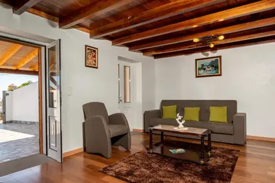 a living room with a couch and a table at Casa Raivinha in Arco da Calheta