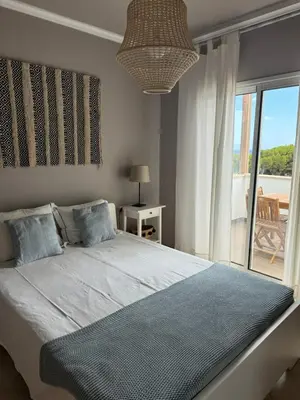 a bedroom with a bed with a view of a patio at Cozy Apartment in Porto Santo
