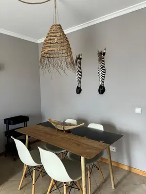 a dining room with a wooden table and chairs at Cozy Apartment in Porto Santo