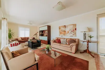 a living room with two couches and a table at Villa Sol by Amazing Madeira in Ponta do Sol