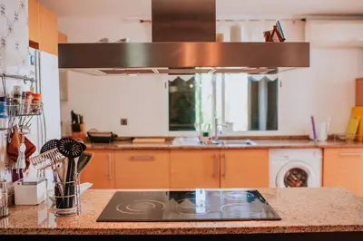 a kitchen with a counter top with a stove at Villa Sol by Amazing Madeira in Ponta do Sol