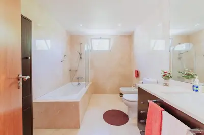 a bathroom with a tub and a toilet and a sink at Villa Sol by Amazing Madeira in Ponta do Sol