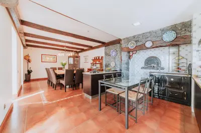 a kitchen and dining room with a table and chairs at Villa Sol by Amazing Madeira in Ponta do Sol