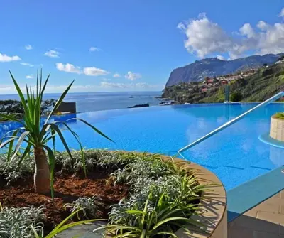 a pool with a view of the ocean and mountains at GuestReady - Vila Formosa in Funchal